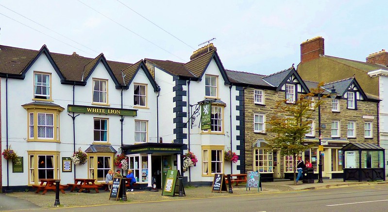 People sitting outside a pub in Machynlleth, Wales