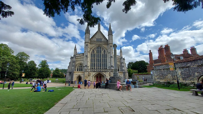 The front of Winchester Cathedral and parkland around it