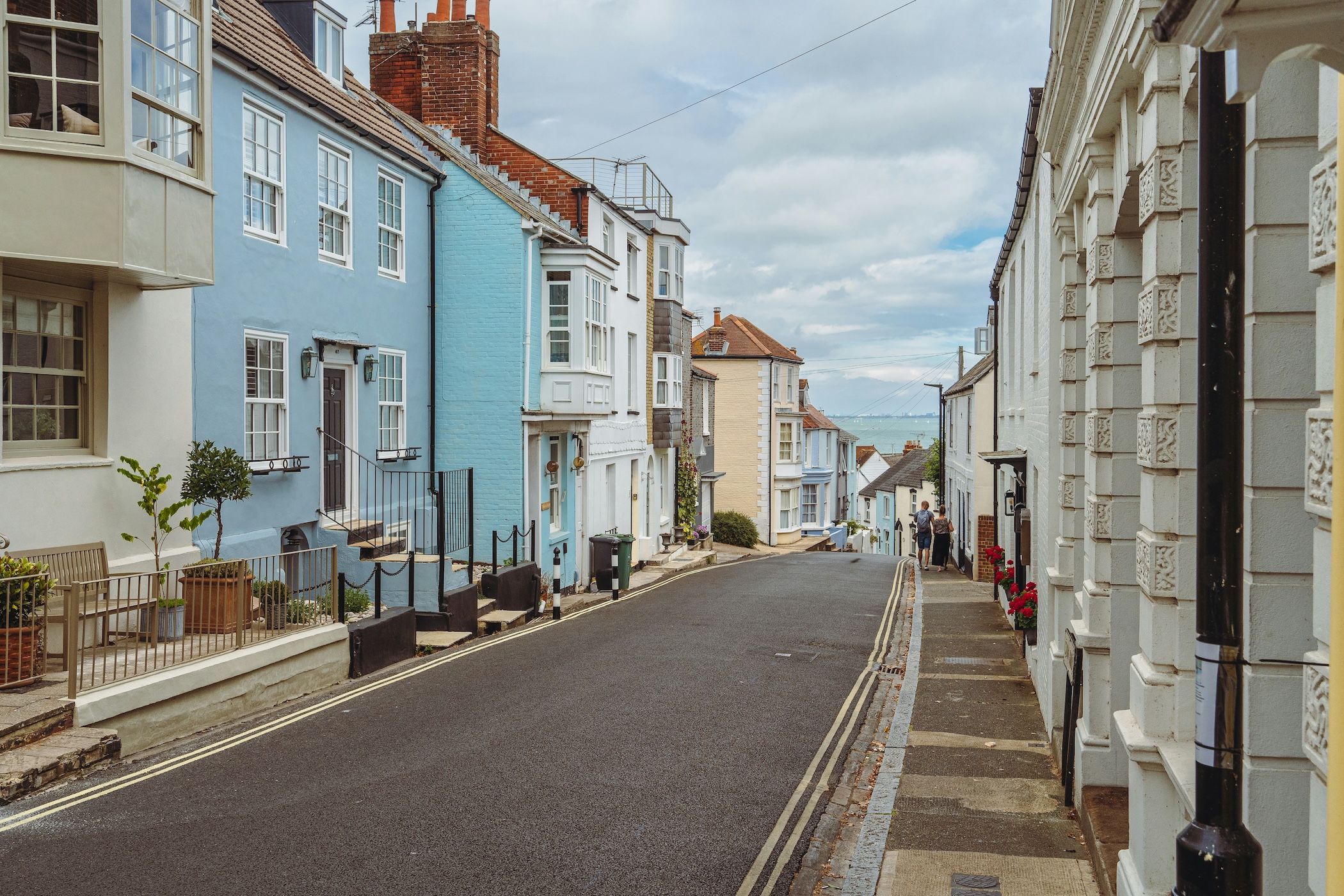 A narrow street with old buildings either side leading down to the sea on the Isle of Wight.