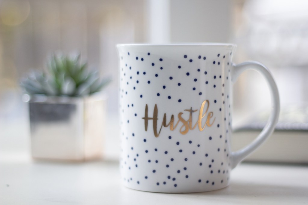 A mug that says 'hustle'