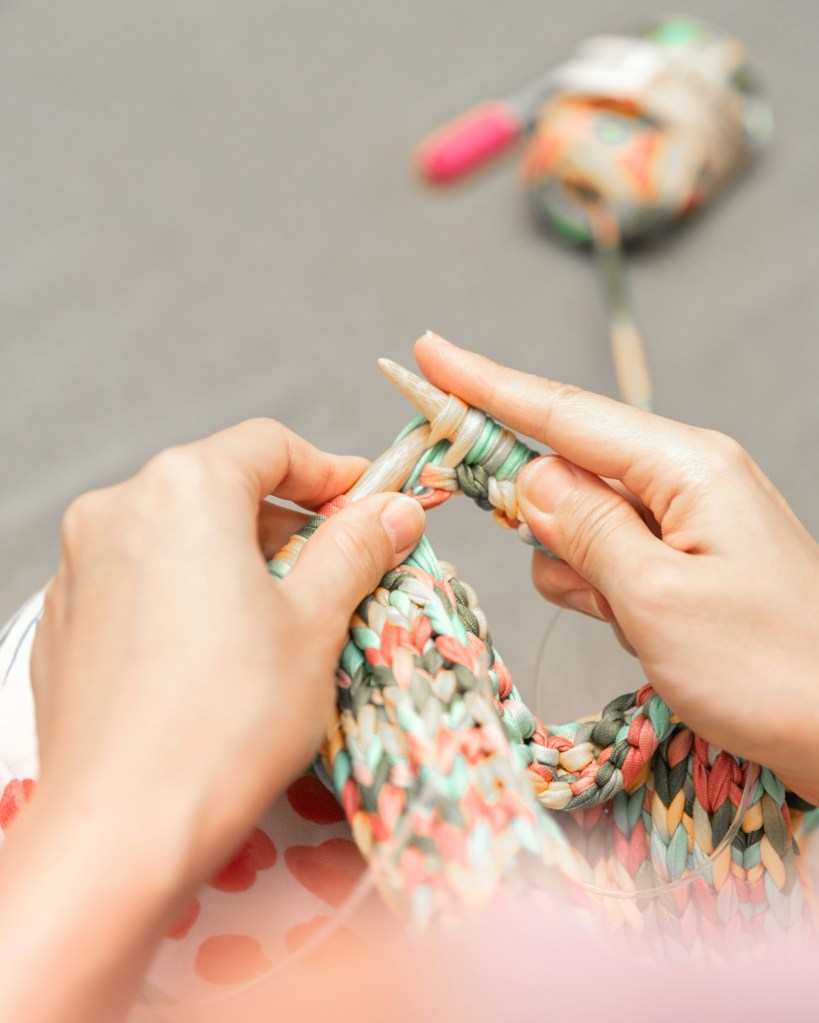 Hands crocheting a blanket