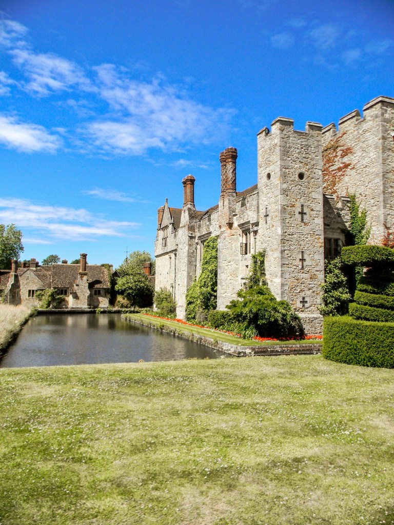 A view of Hever Castle and its moat on a sunny day.